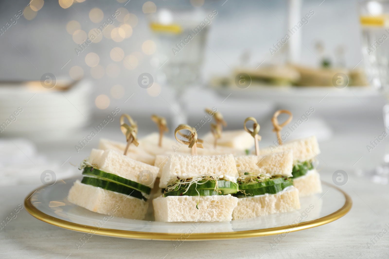 Photo of Plate with traditional English cucumber sandwiches on table. Space for text