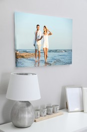 Image of Canvas with printed photo of young couple on white wall in room