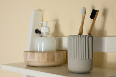 Photo of Shelving unit with toiletries near light wall indoors. Bathroom interior element