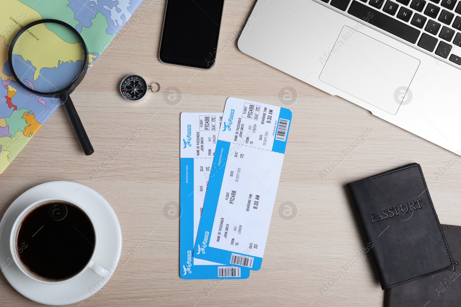 Photo of Flat lay composition with avia tickets and passport on wooden table. Travel agency concept