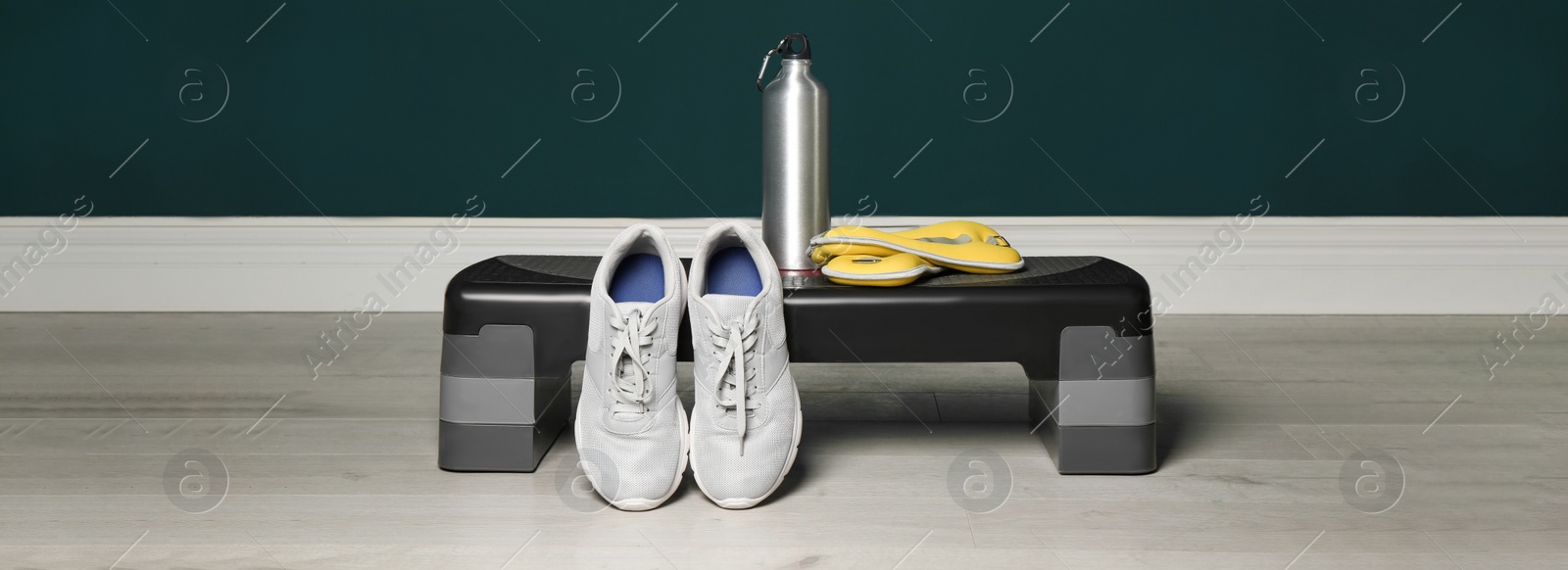 Image of Step platform and different sports equipment indoors. Banner design