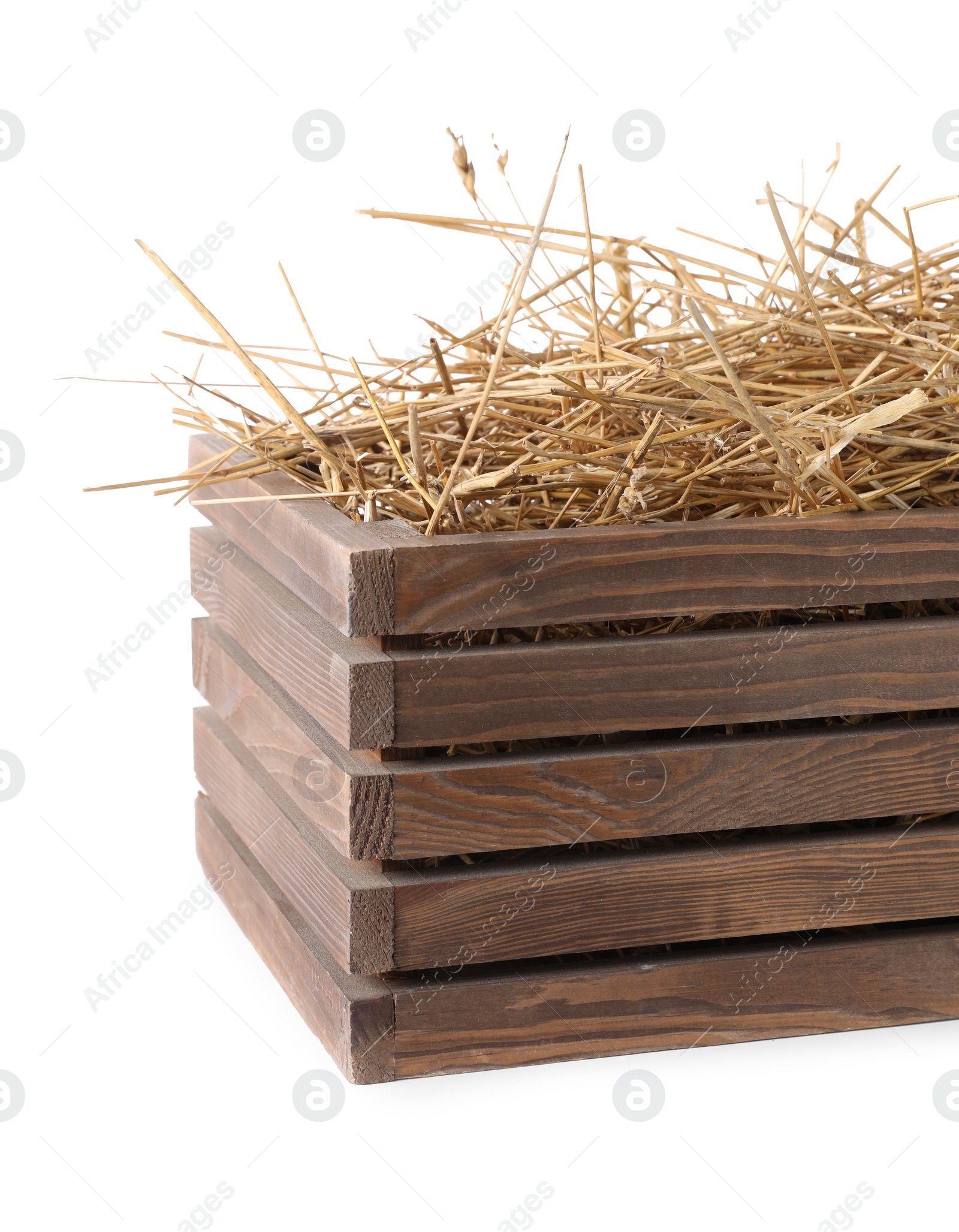 Photo of Dried straw in wooden crate isolated on white