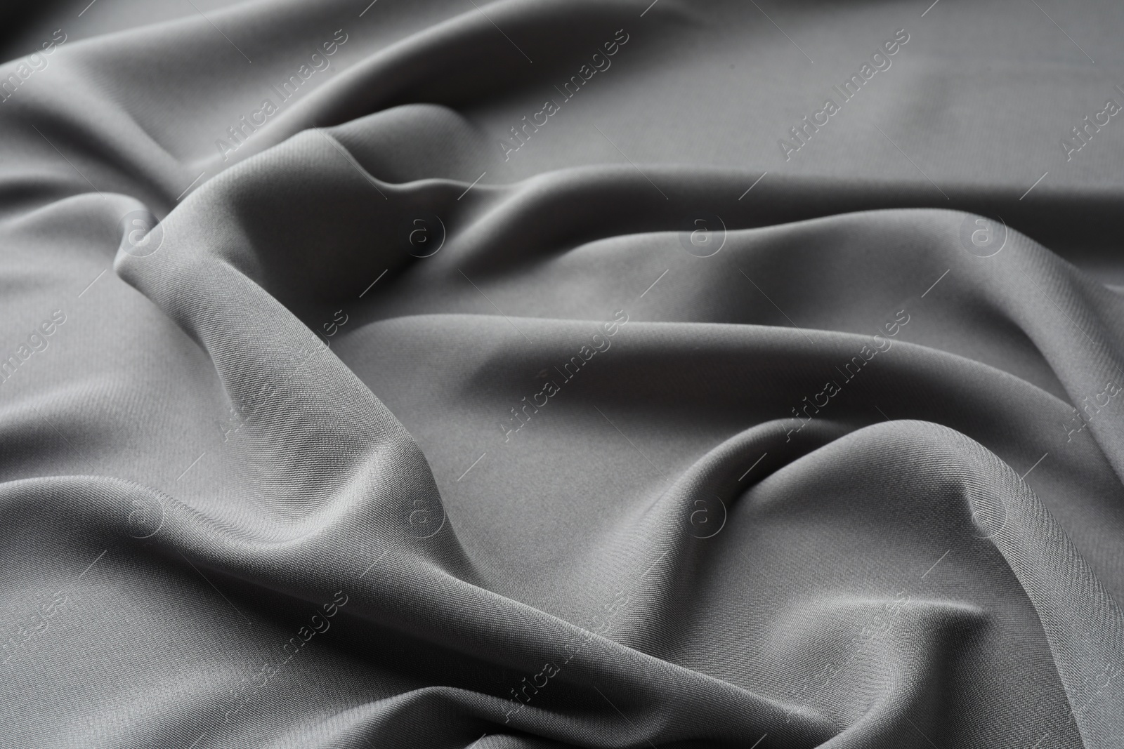 Photo of Texture of grey crumpled silk fabric as background, closeup