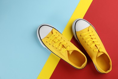 Pair of trendy sneakers on color background, flat lay. Space for text