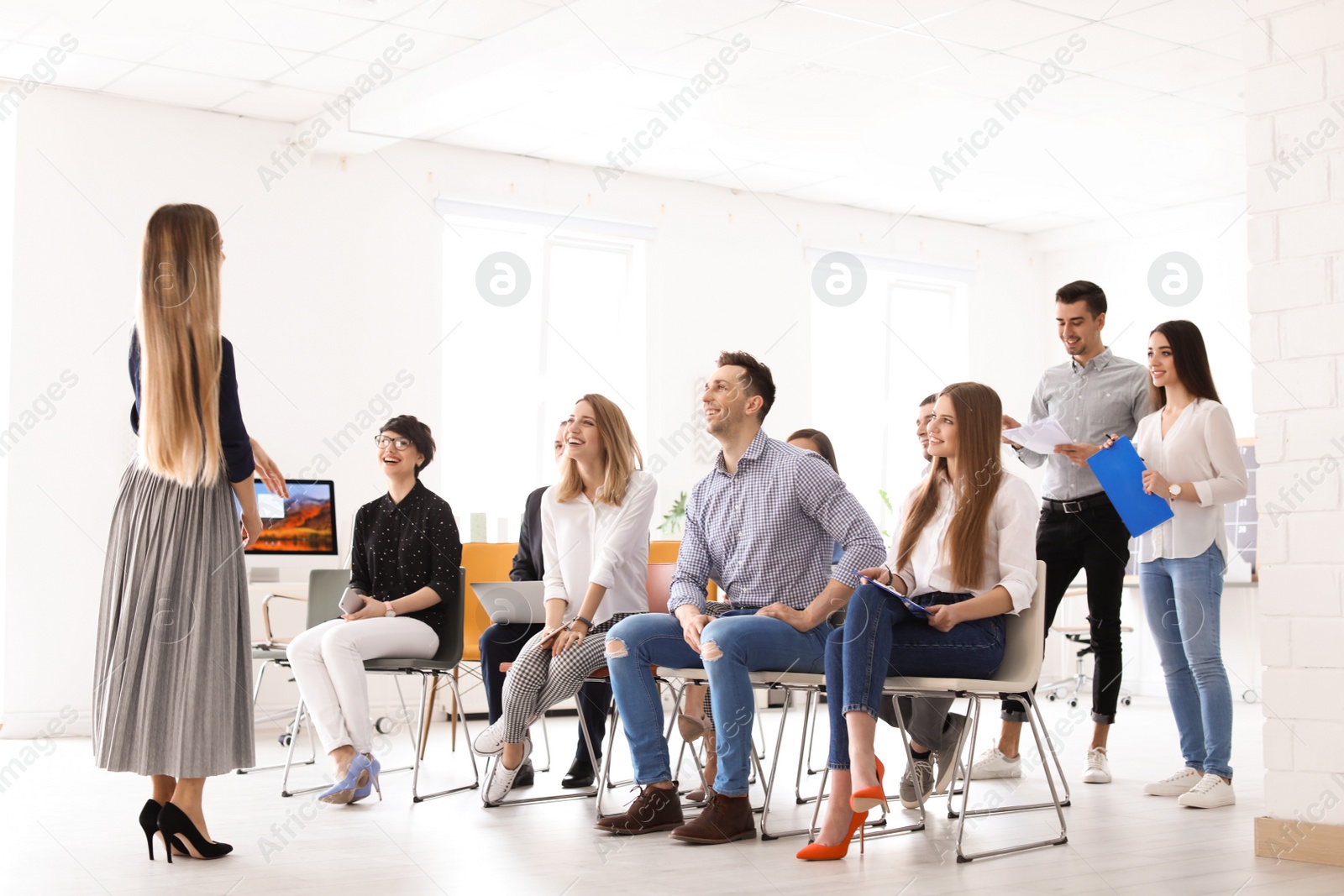 Photo of Female business trainer giving lecture in office