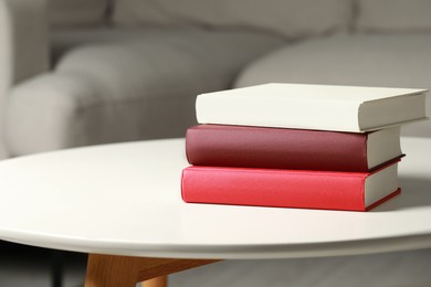 Many different books stacked on white table indoors, space for text