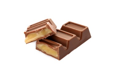 Photo of Pieces of delicious chocolate bar on white background