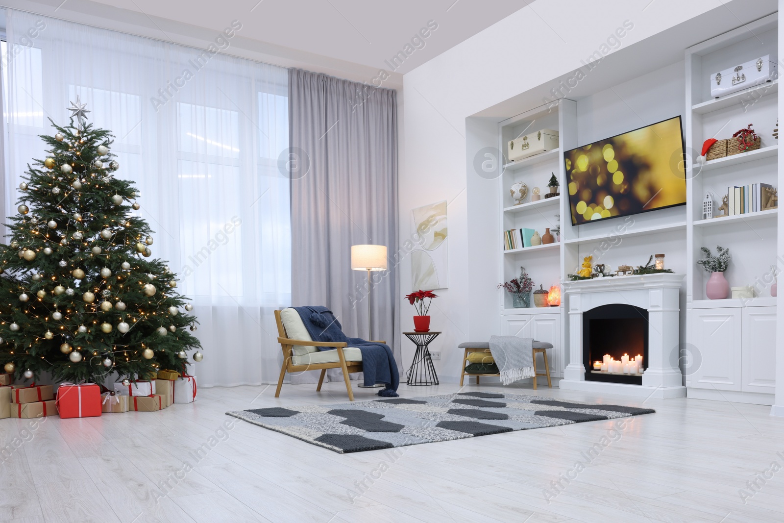 Photo of Beautiful tree with festive lights and Christmas decor in living room. Interior design