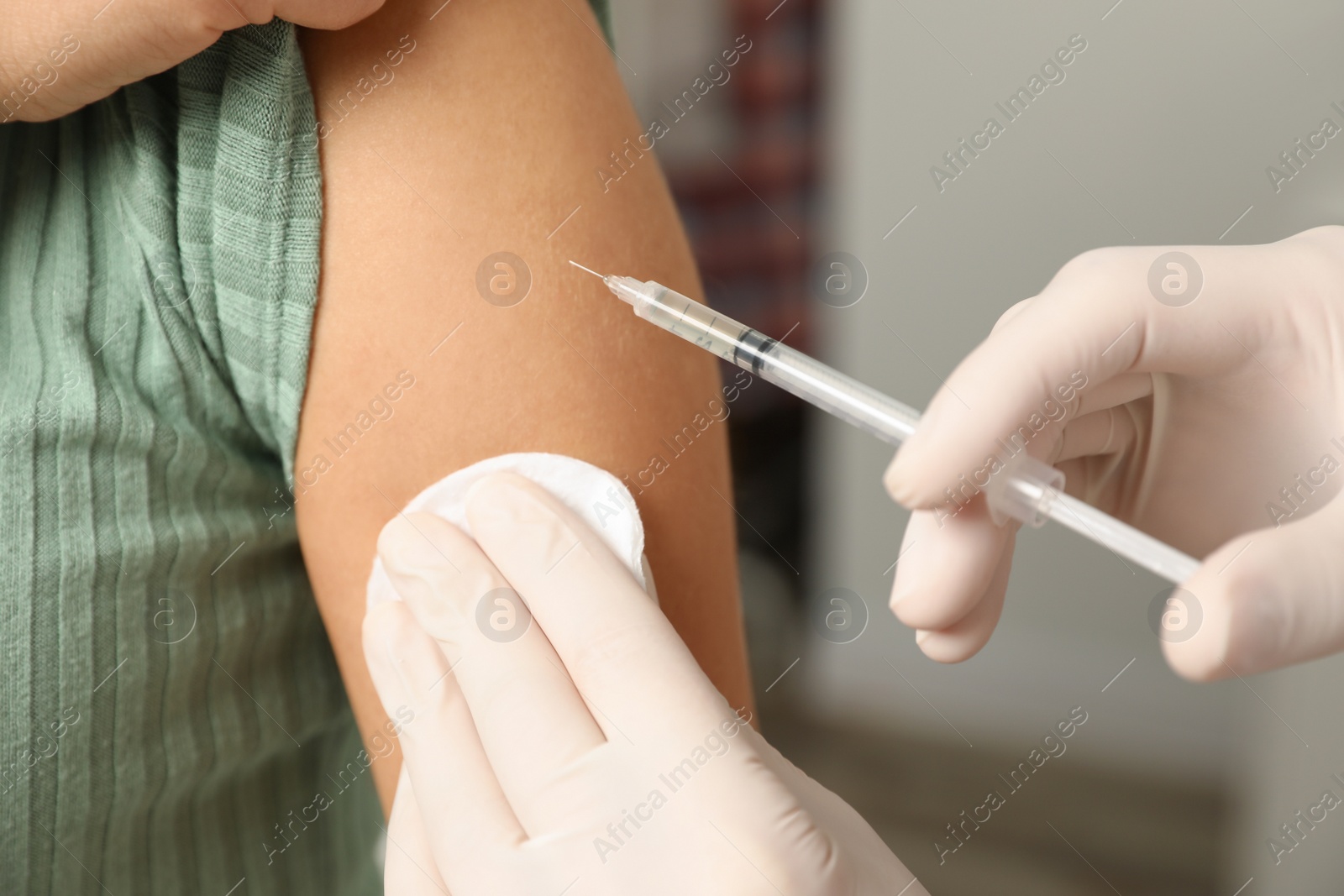 Photo of Doctor giving injection to patient in hospital, closeup. Vaccination day