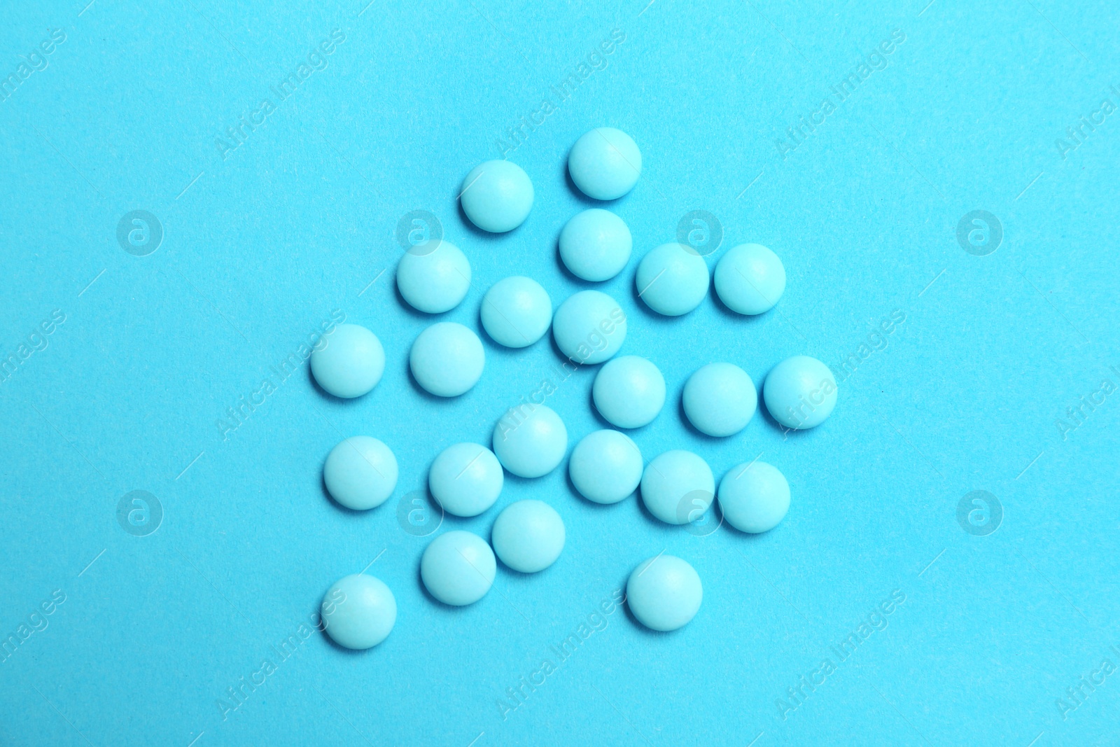 Photo of Blue pills on color background