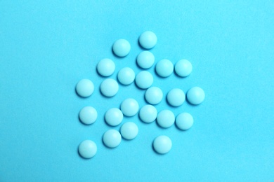 Photo of Blue pills on color background