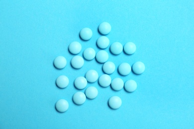 Blue pills on color background