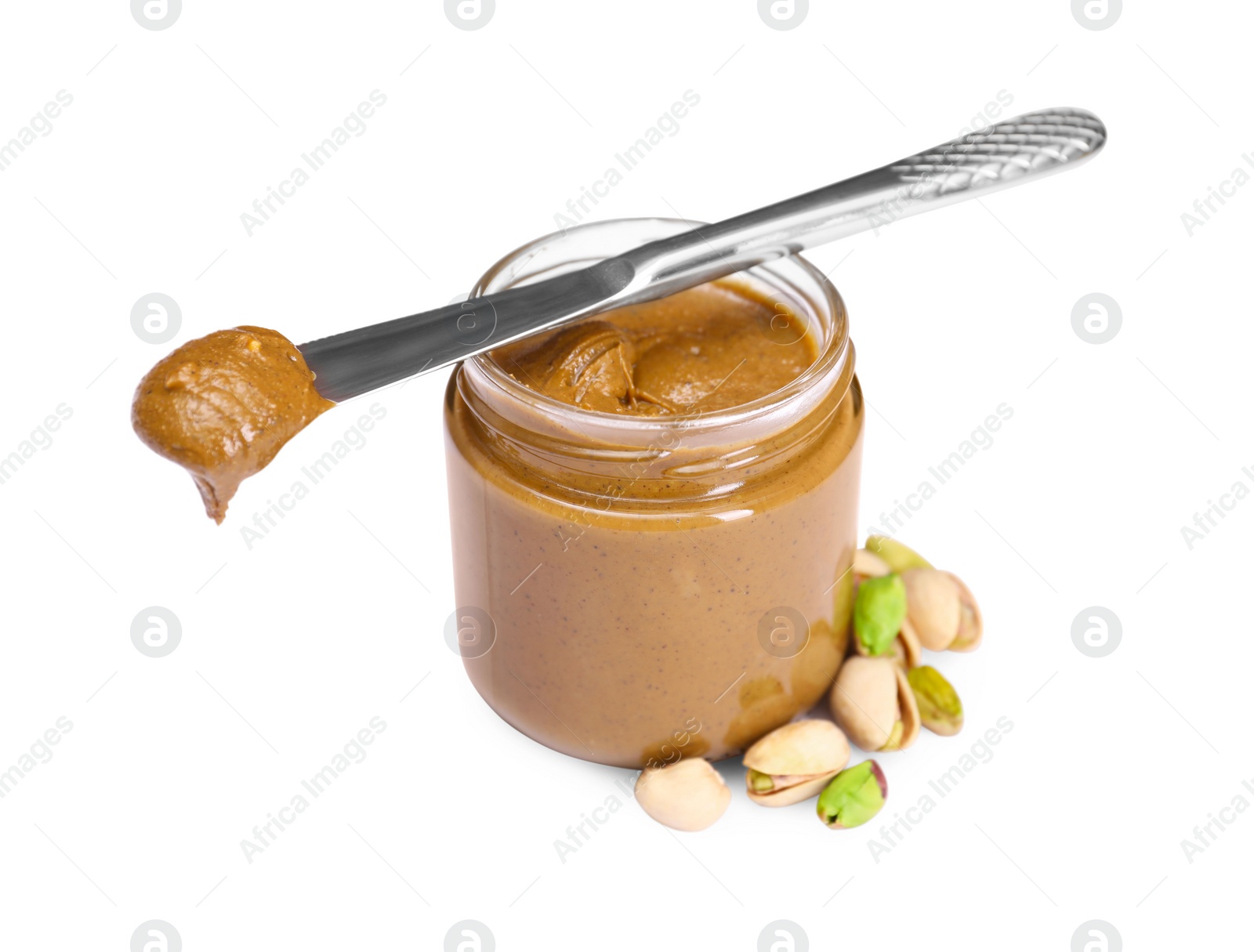 Photo of Tasty nut paste in jar, knife and pistachios isolated on white