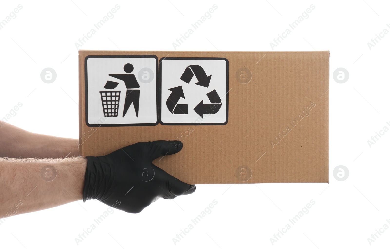 Photo of Courier holding cardboard box with different packaging symbols on white background, closeup. Parcel delivery