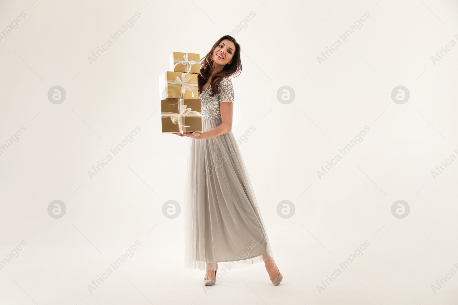 Photo of Beautiful woman with Christmas gifts on white background