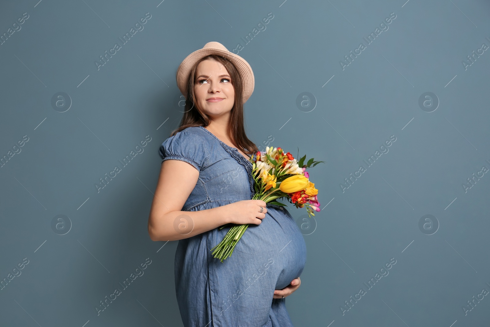 Photo of Beautiful pregnant woman on color background