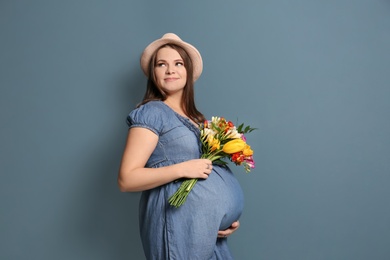 Photo of Beautiful pregnant woman on color background