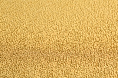 Photo of Texture of beautiful yellow fabric as background, closeup