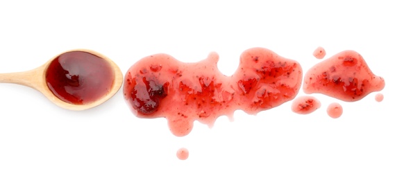 Photo of Spoon and sweet berry jam on white background