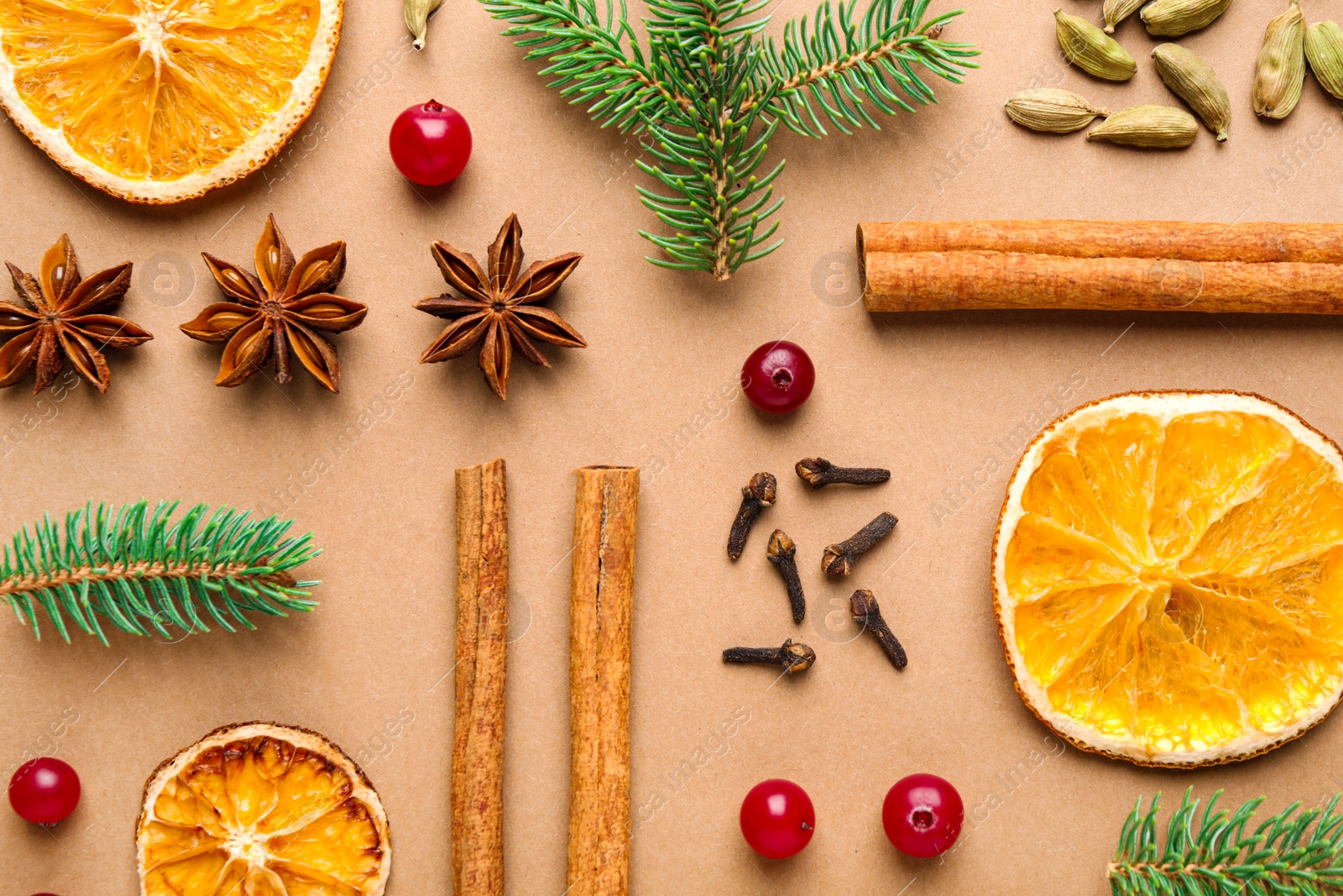 Photo of Flat lay composition with mulled wine ingredients and fir branches on brown background