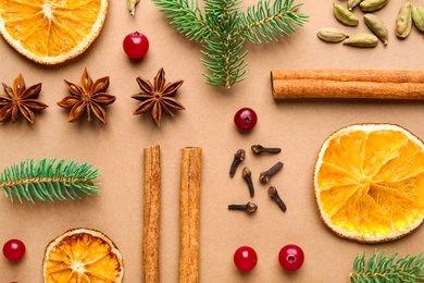 Flat lay composition with mulled wine ingredients and fir branches on brown background