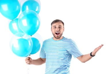 Young man with air balloons on white background