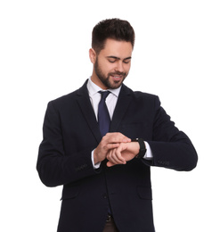 Young businessman checking time on white background