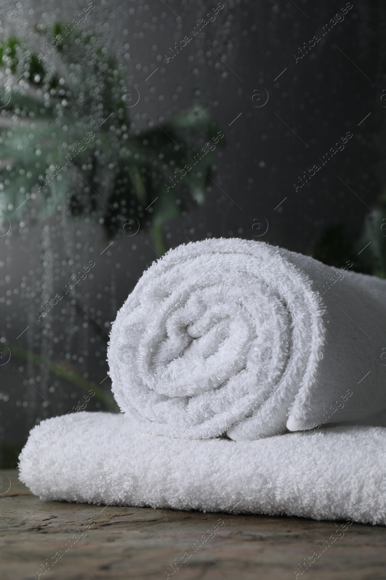 Photo of White terry towels on table in bathroom