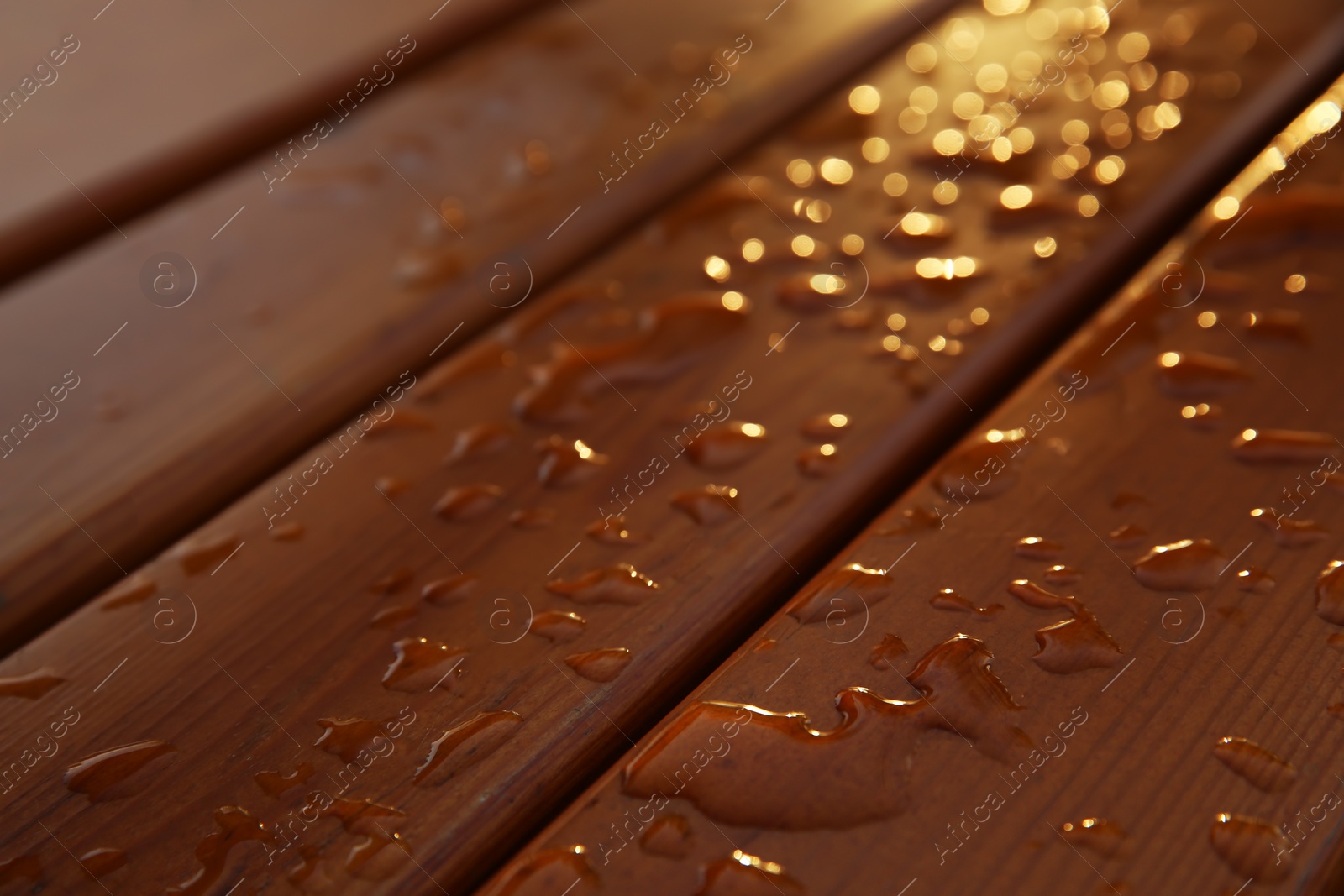 Photo of Water drops on wooden planks as background, closeup