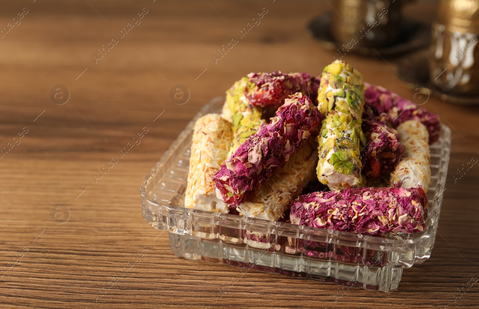 Photo of Turkish delight dessert on wooden table. Space for text