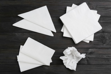 Photo of Clean napkins on wooden table, flat lay