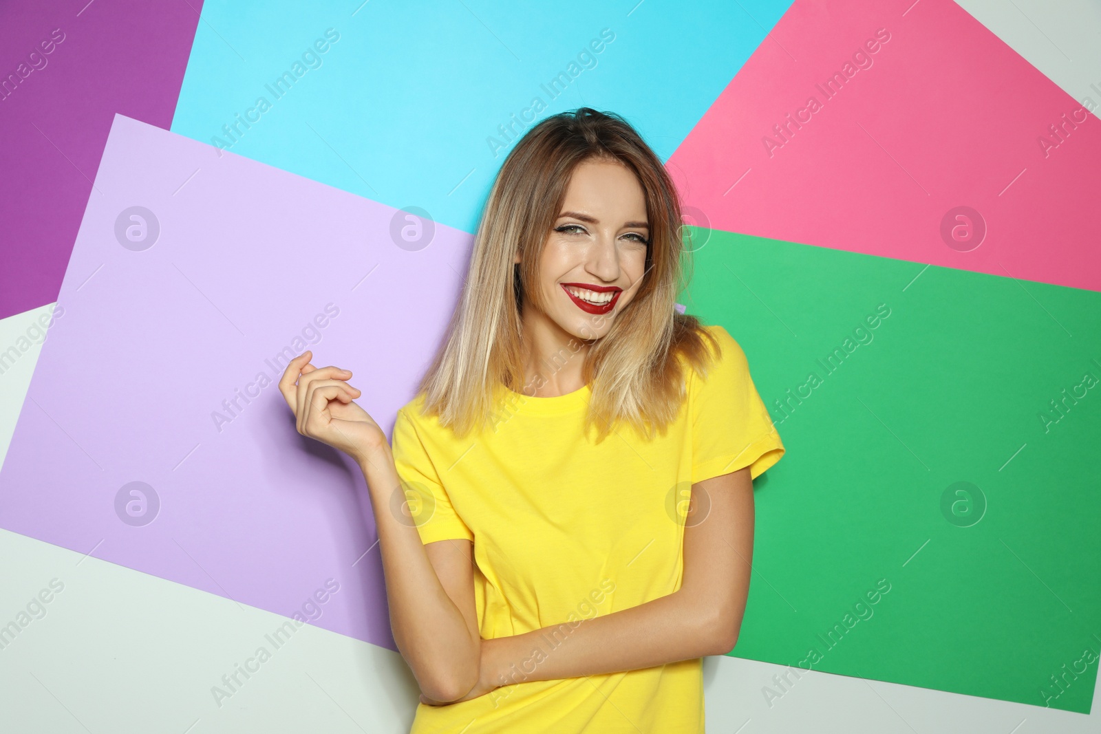 Photo of Beautiful young woman with healthy long blonde hair on color background