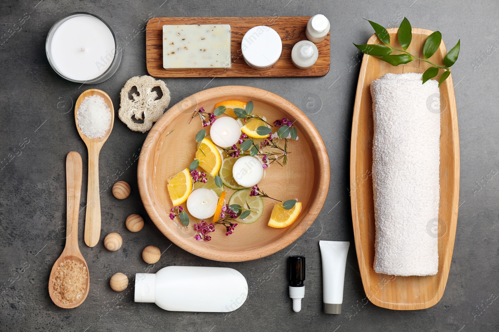 Photo of Composition with spa accessories and flowers on grey background