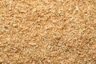 Photo of Dry natural sawdust as background, top view