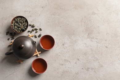 Flat lay composition with cups of Tie Guan Yin oolong tea and space for text on table