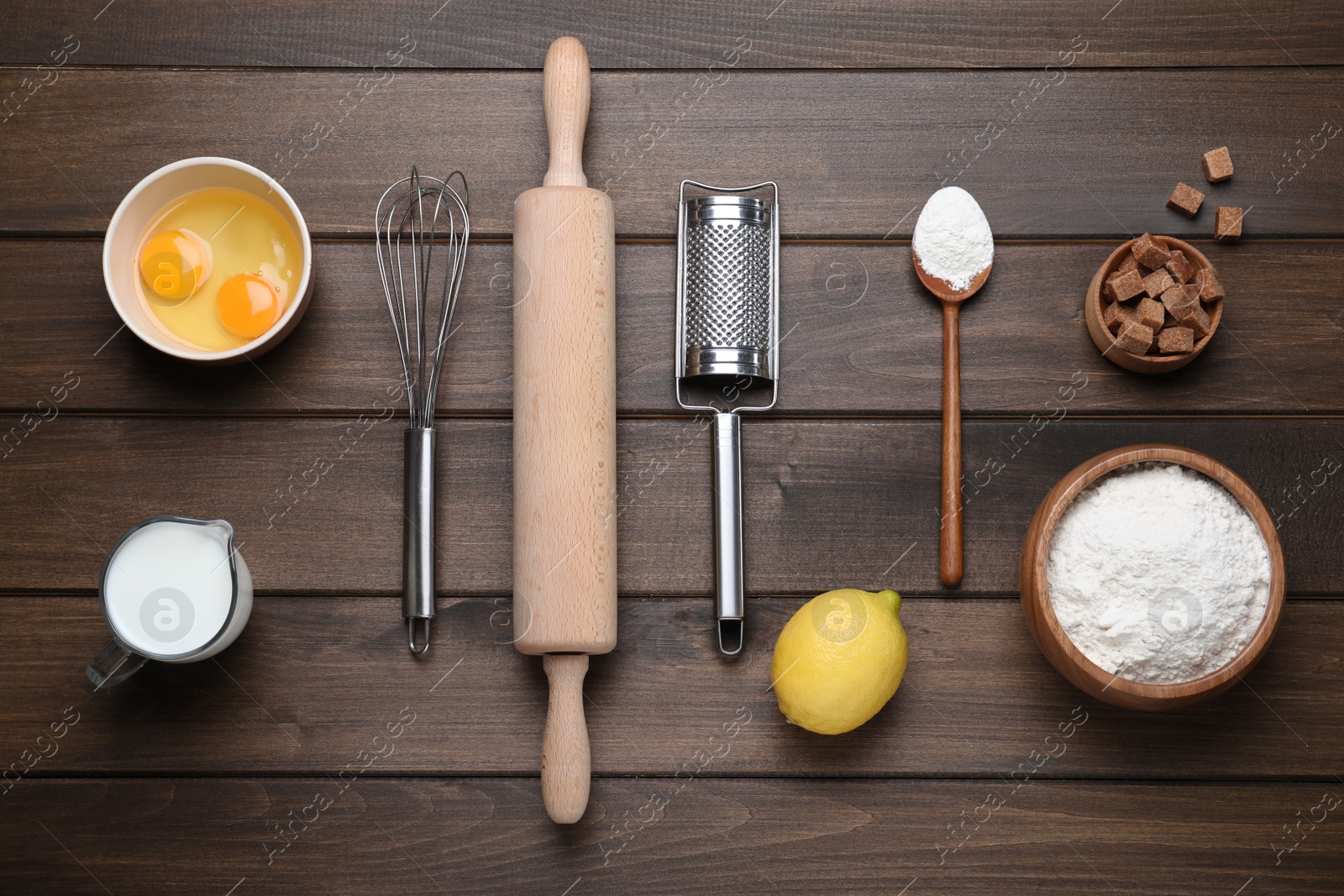 Photo of Cooking utensils and ingredients on wooden table, flat lay