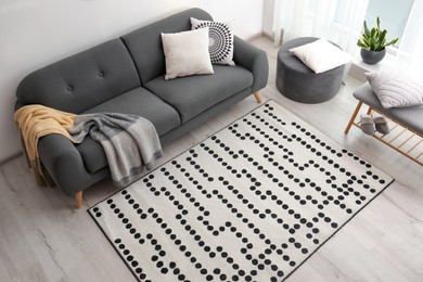 Photo of Living room interior with comfortable sofa and stylish rug, above view