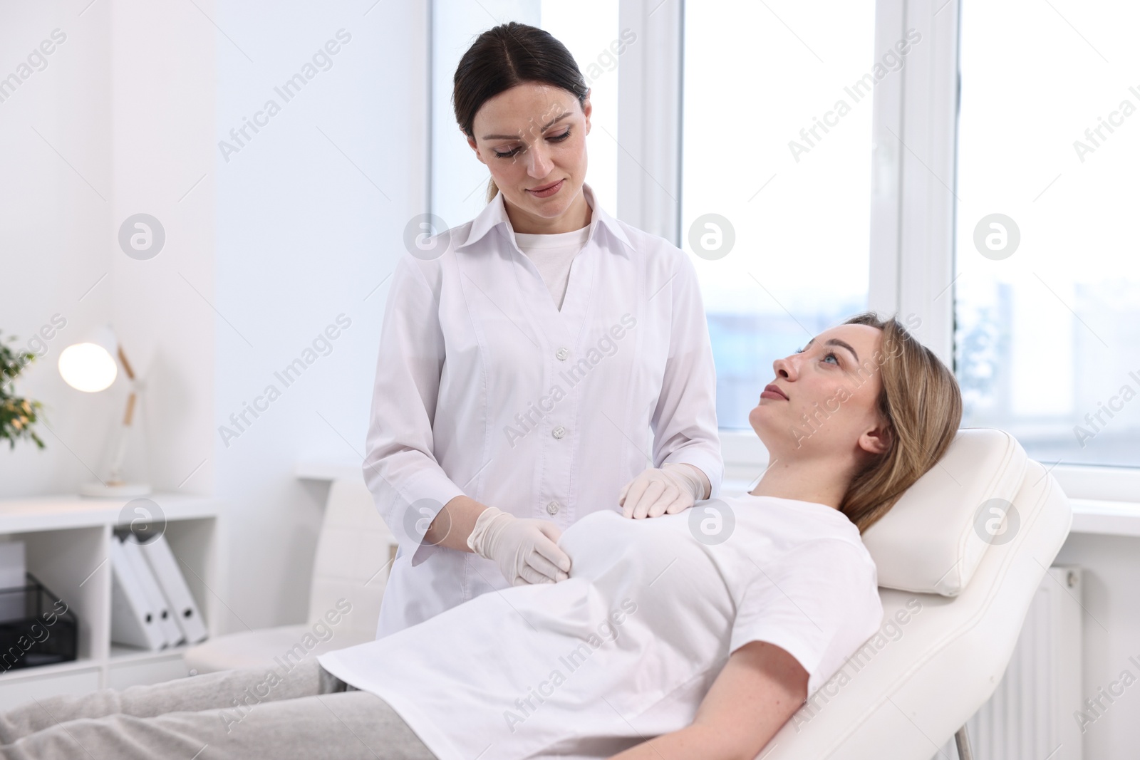 Photo of Mammologist checking young woman's breast in hospital