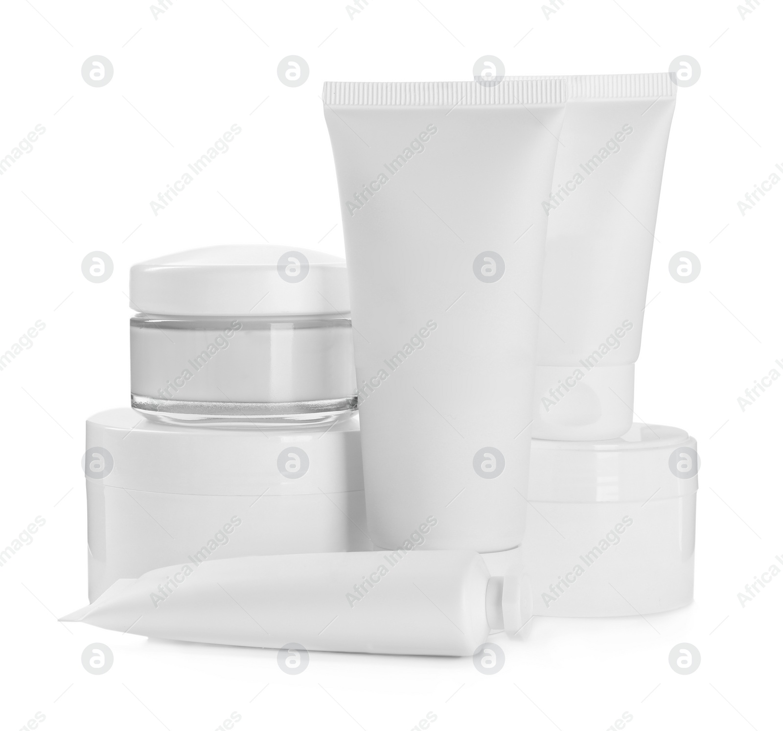 Photo of Blank tubes and jars of cosmetic products on white background