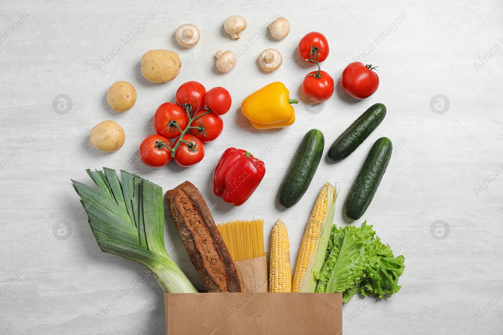 Photo of Fresh vegetables and other products on light grey background, flat lay