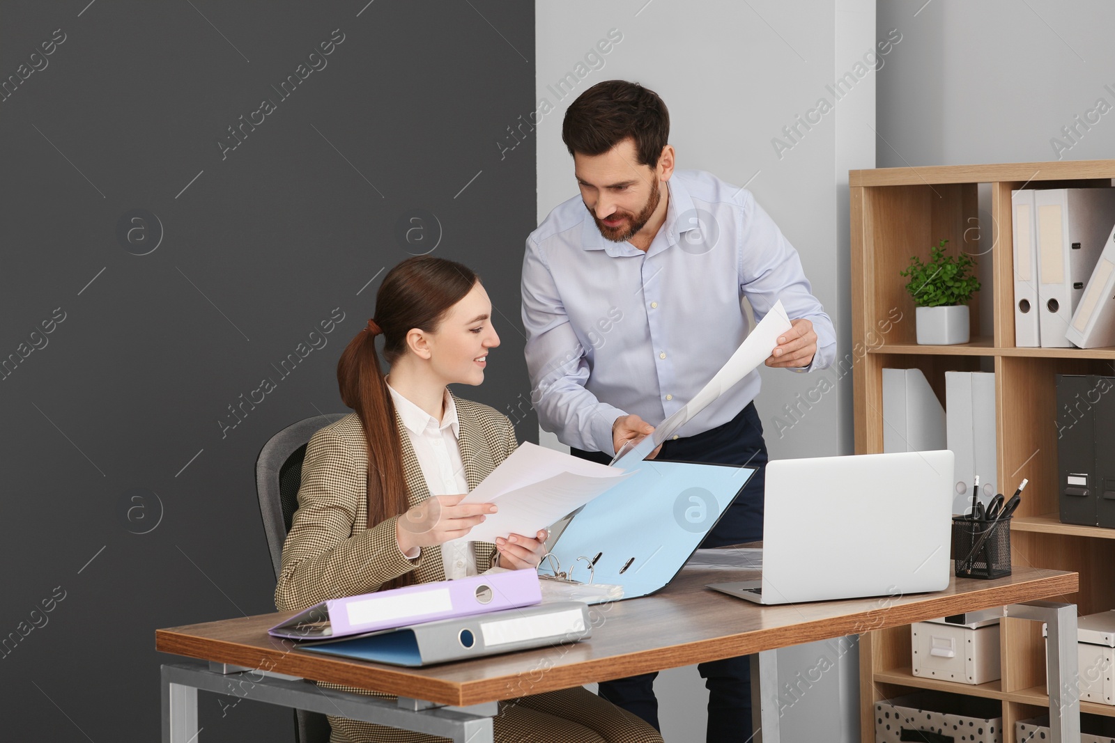 Photo of Businesspeople working together with documents in office