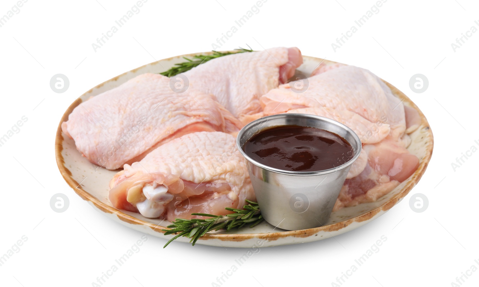 Photo of Plate with marinade, raw chicken and rosemary isolated on white