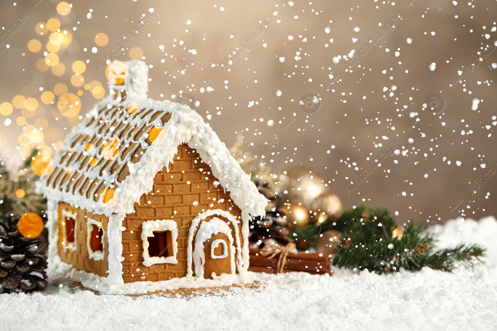 Photo of Beautiful gingerbread house decorated with icing on snow, space for text