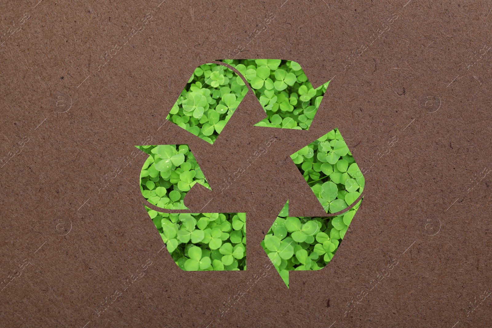 Image of Recycling symbol made of green leaves on kraft paper
