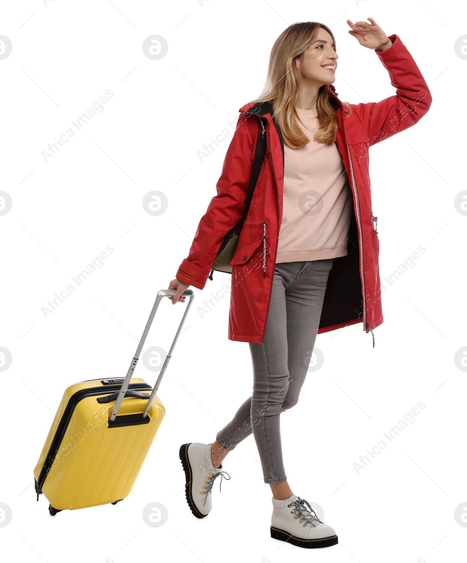 Photo of Woman with suitcase walking on white background. Winter travel