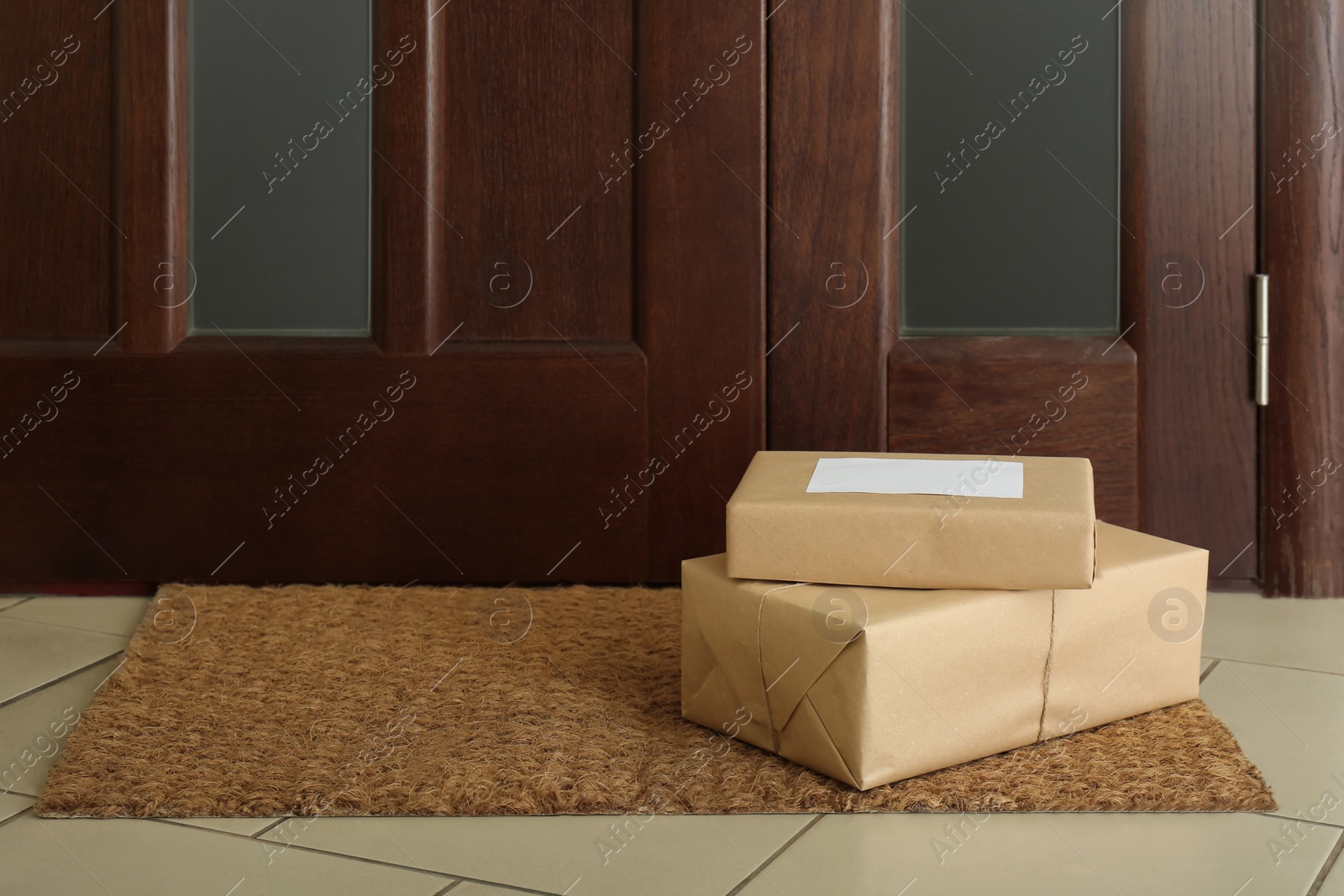 Photo of Parcels on rug near door. Delivery service