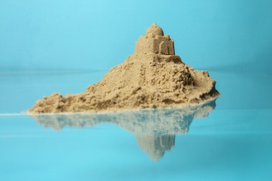Photo of Pile of sand with sultan's palace on light blue background. Beautiful castle