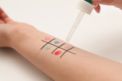 Photo of Patient undergoing skin allergy test at light table, closeup