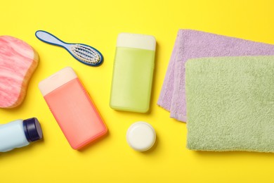 Flat lay composition with baby cosmetic products on yellow background