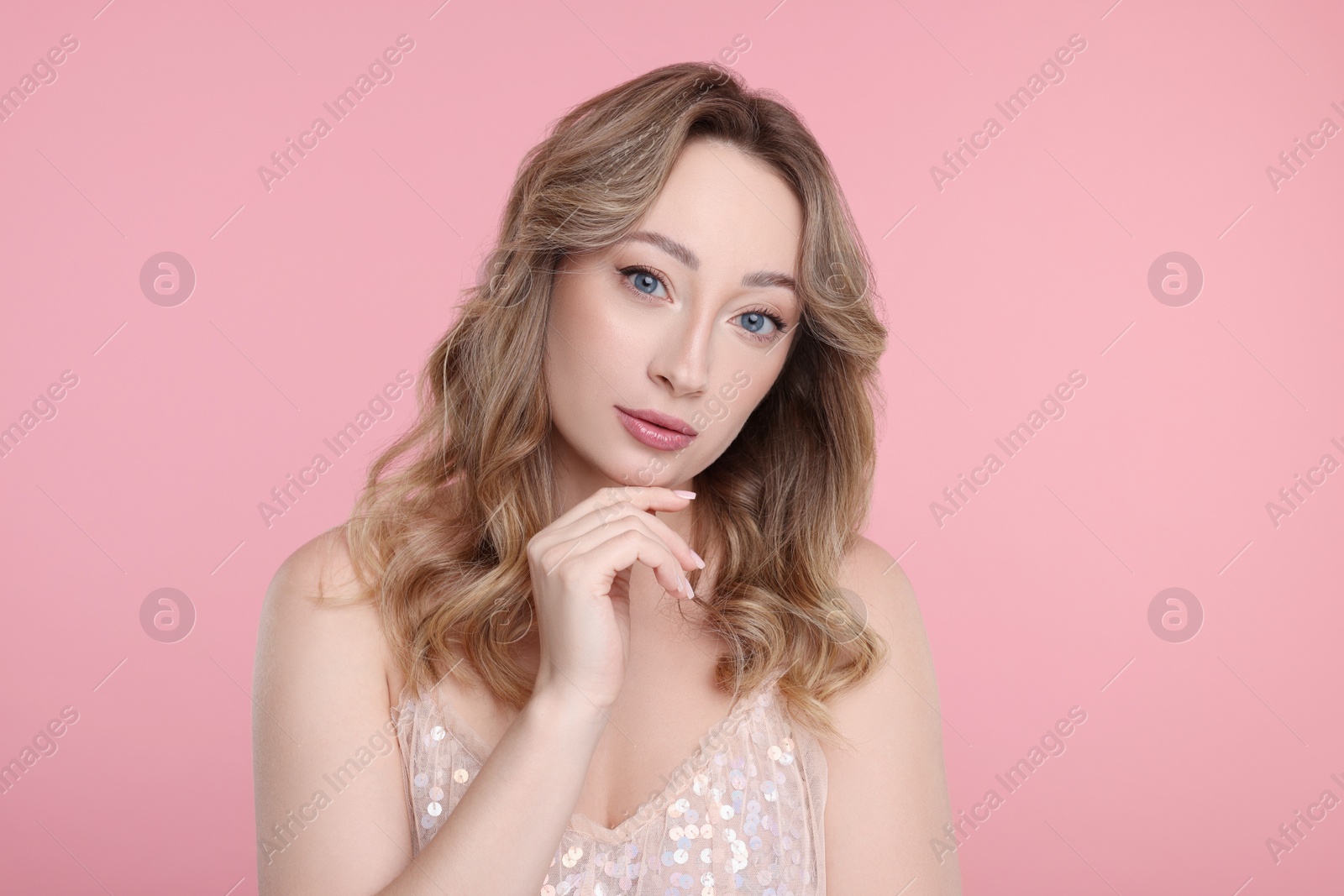 Photo of Portrait of beautiful woman on pink background